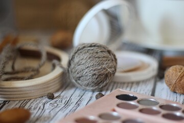 Knitting process, needles, cup of tea and different objects on the table beautiful photo	
