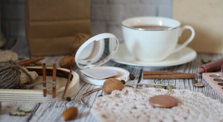 Table different woman objects cup of tea needlework knitting doily beige pastel calm colors cozy...