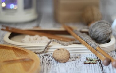 Knitting process, needles, cup of tea and different objects on the table beautiful photo	

