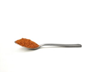 Chili powder on spoon isolated on white background