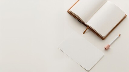 Stationery and a pencil placed beside an open notebook on a wooden desk.
