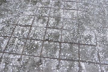 Damaged concrete floor and rusty wire mesh background