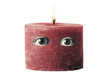 Melting vintage candle with unique eyes featured in wax