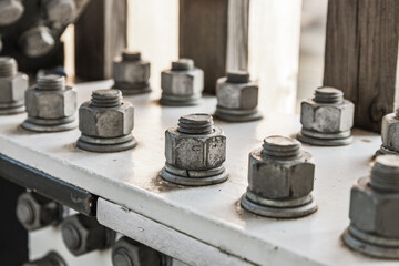 Close up of galvanized nuts and bolts securing steel flange in modern architectural frame