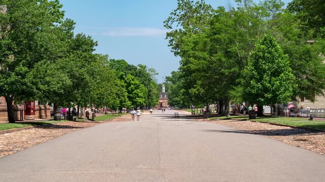 Time-lapse of pedestrians walking along Duke of Gloucester Street in Williamsburg, Virginia, with the historic Capitol building at the end of the street.