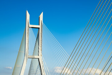 Fototapeta premium Cable-stayed bridge tower under blue sky and clouds