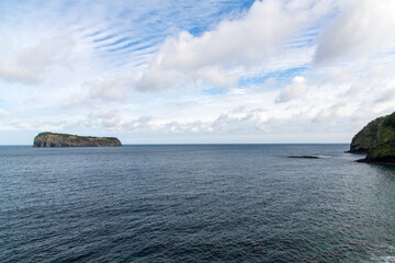 tranquil seascape with rock at the seaside