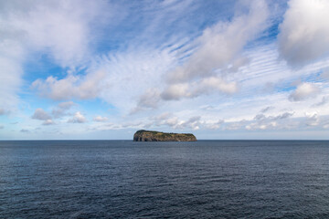 tranquil seascape with rock at the seaside