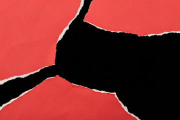 red torn paper on black background 