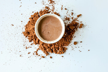Top view of cocoa drink and cocoa powder on white background