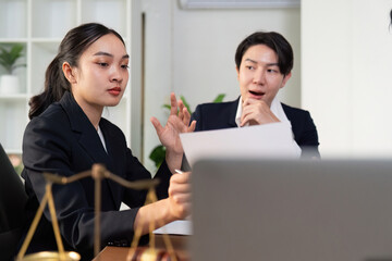Legal Discussion. Female lawyer presenting case details to colleague in office.