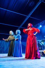 Drag Queens Perform During a Vibrant Evening Show at a Festival in a Large Tent Setting