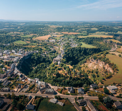 Aerial view of the dramatic canyon carved by the Dourdou de Conques river, a stunning natural amphitheater encircling a village, Bozouls, Occitanie, France.