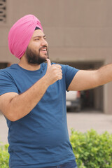 Vertical Photo of Sikh Indian Man Talking on Video Call