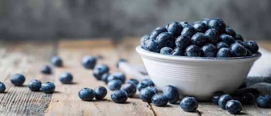 The bowl of fresh blueberries on a rustic wooden table.