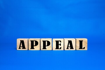Appeal word on cube wood. light blue background. cube wood concept.