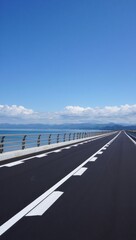Open road to serene horizon over calm waters