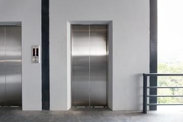 Elevator door with clean concrete floor. Infrastructure in commercial building. Modern design ideal...