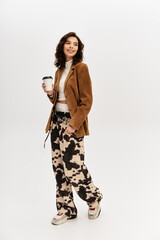 Stylish young woman showcases trendy cow print pants in a modern studio setting