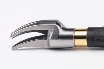 Obraz premium Close-up of a metallic multi-tool with a sleek design, showcasing its pronged end against a white background