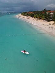 Aerial drone view of Seven Mile Beach in Negril, Jamaica, revealing crystal-clear Caribbean waters,...