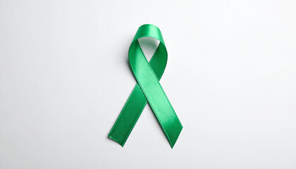 Green awareness ribbon on white backdrop. International symbol of mental health awareness.
