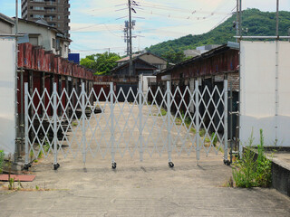 A steel gate to the demolition site.
This is for an old rental garage area.