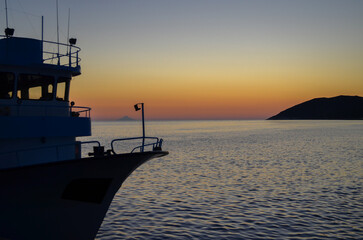 Boat Silhouette at Sunset on Calm Sea