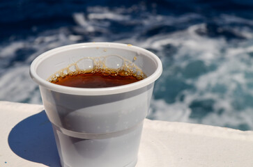 Hot Tea in Plastic Cup on Ferry with Sea Background