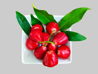 close up Red rose apple in a white porcelain plate on gray background