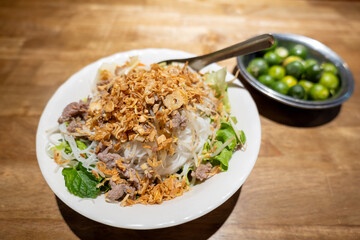 Bun Bo Xao, a Vietnamese noodle salad made with marinated flank steak, vermicelli noodles and fresh vegetables.