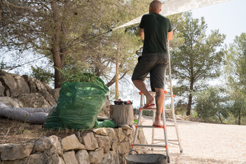 Man climbing on the ladder outdoors