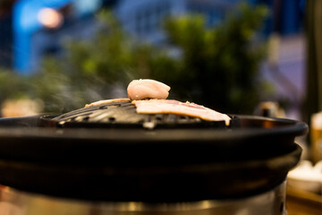 Sliced pork grilled on hot pan. Thai style barbecue or Mookata. Selective focus