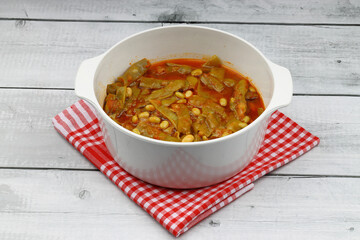 Homemade stewed green beans, tomatoes, garlic with olive oil. Zeytinyagli fasulye traditional food. Turkish cuisine.
