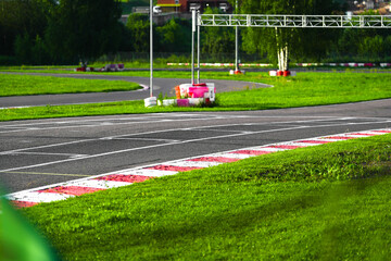 A clean racing track with tire barriers, green grass, and sunset lighting. Perfect for motorsport,...