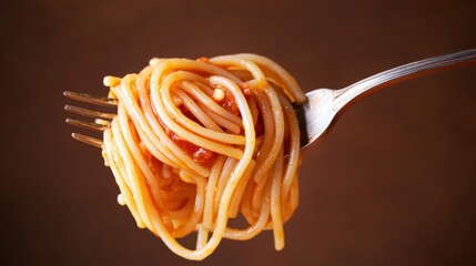 Delicious Pasta on Metal Fork with Red Sauce Against Brown Backdrop