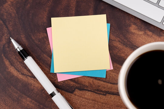 Top view of Blank sticky adhesive note with a cup of coffee