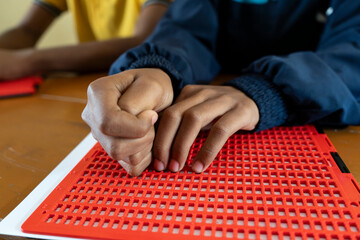 Visually impaired students writes using the Braille system