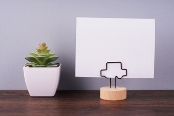 Blank paper note on paper holder on to of desk