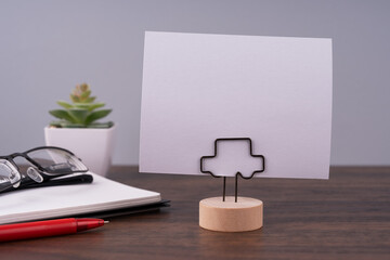 Blank paper note on paper holder on to of desk