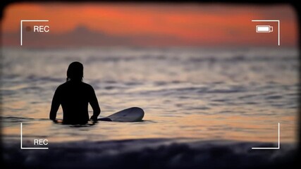 Blurred sunset view through recording screen; silhouette of person in ocean - Powered by Adobe