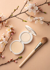 Elegant compact powder and makeup brush with delicate cherry blossoms on a soft background