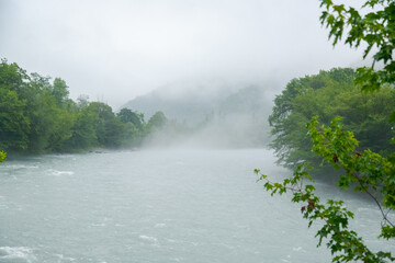 River is flowing with rain and mist