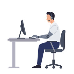 Man with prosthetic arm typing at office computer