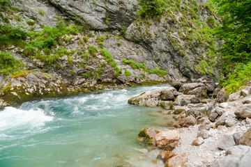 Fototapeta premium River with a green rock in the middle