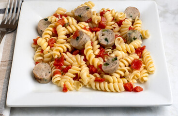 rotini pasta  served with tomatoes and chicken sausage