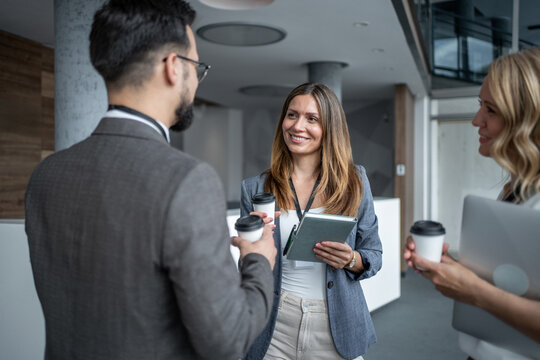 Business people chatting during coffee break at conference - Powered by Adobe