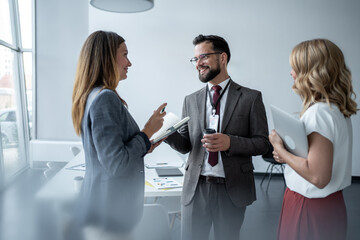Business people talking during informal office meeting
