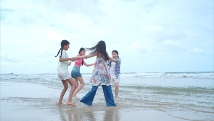 Fototapeta premium Happy children playing together in the sea, enjoying a fun summer day at the beach