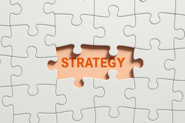 Fototapeta premium Strategy Puzzle: The word strategy shines through the missing puzzle, symbolizing the critical piece required for a cohesive and successful plan. This evokes the essence of planning.